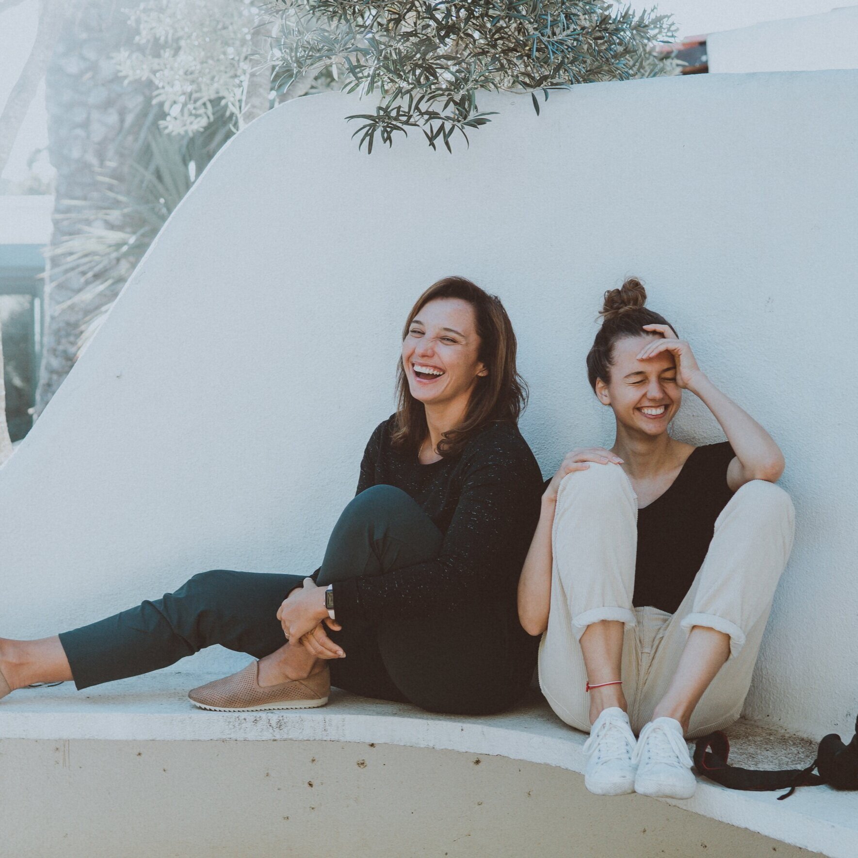 two-women-sitting-on-white-bench-1549280.jpg
